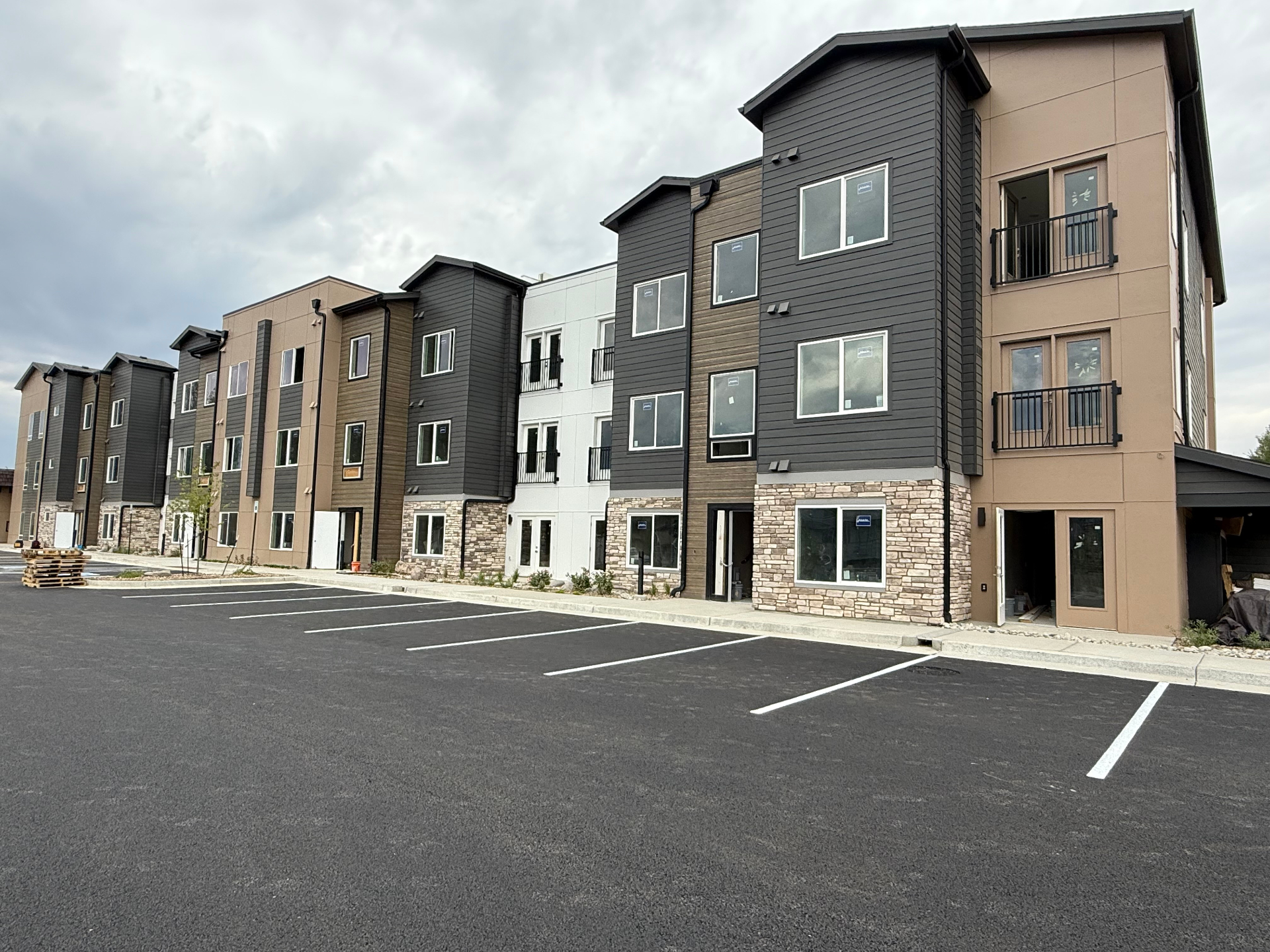 Completed multifamily apartment building with stacked stone wainscot and column bases in Colorado