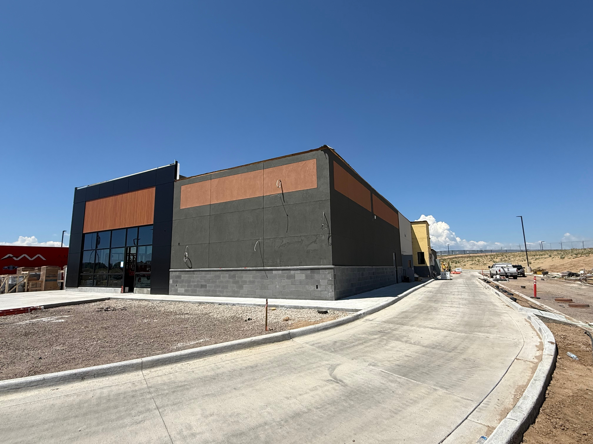 Two-tone commercial stucco corner with copper accents in Colorado